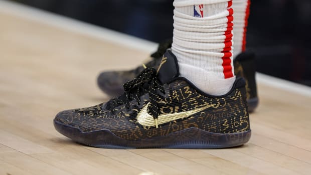 View of black and gold Nike Kobe shoes.